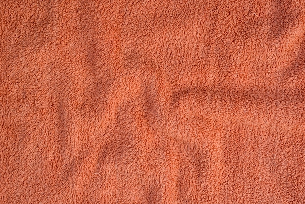 Textura de toalha de terry com dobras. cor coral