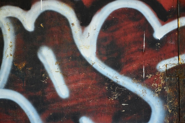 Textura de um fragmento da parede com pintura de graffiti que é retratada nele Uma imagem de um pedaço de desenho de graffiti como uma foto sobre tópicos de arte de rua e cultura de graffiti