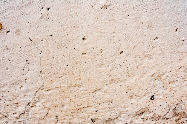 Textura de um muro de concreto com rachaduras e arranhões