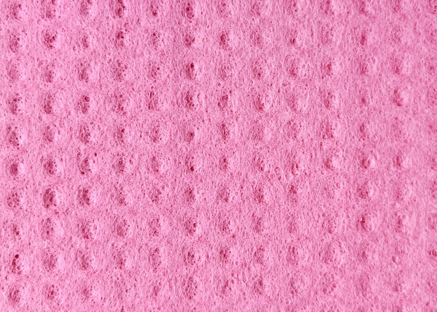 Textura de um pano de cozinha rosa sintético de perto