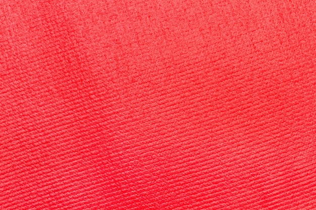 Textura de um tapete de ioga vermelho em uma visão de perto