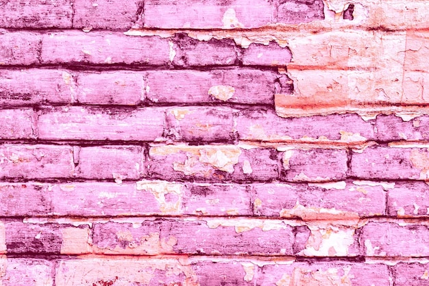 Foto textura de uma parede de tijolos com rachaduras e arranhões que podem ser usados como fundo