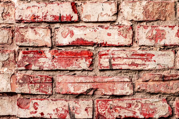 Foto textura de uma parede de tijolos com rachaduras e arranhões