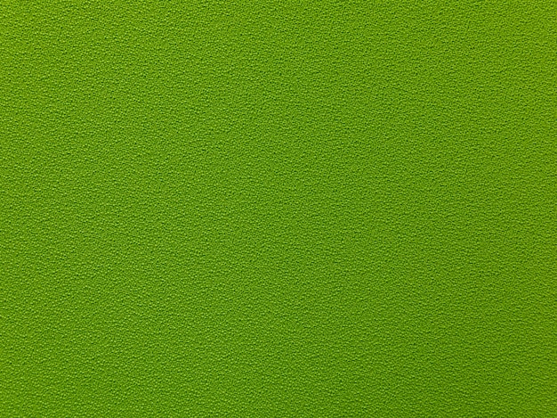 Foto textura densa verde oscuro de la tela. fondo verde de la materia textil.