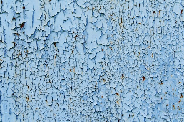 Textura do fundo da parede de ferro enferrujado azul e cinza vintage com muitas camadas de tinta e ferrugem