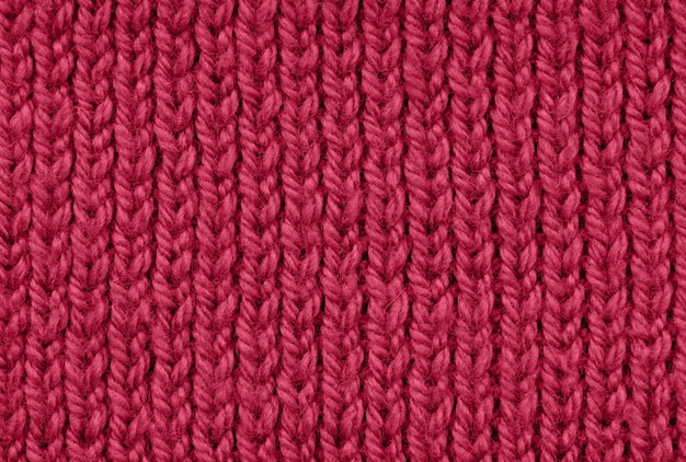 Textura do padrão de fundo de cor magenta viva tricotado