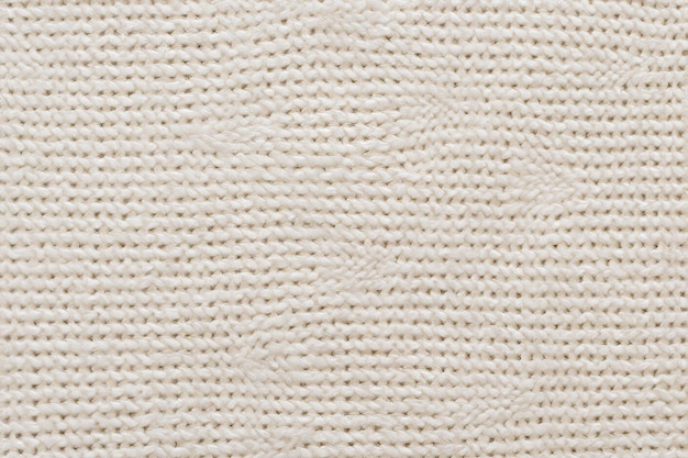 Textura do tecido de uma camisola branca quente