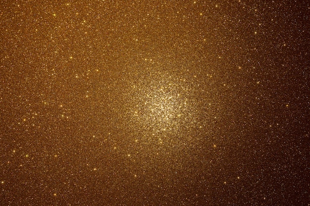 Textura dourada com brilhos e um ponto de luz no centro.