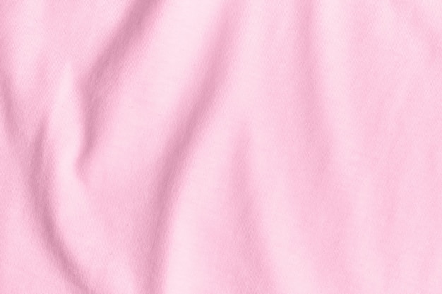 Foto textura e fundo de tecido rosa amassado.