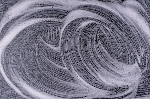 Textura de espuma abstracta sobre fondo negro Burbujas de espuma de jabón fondo oscuro abstracto