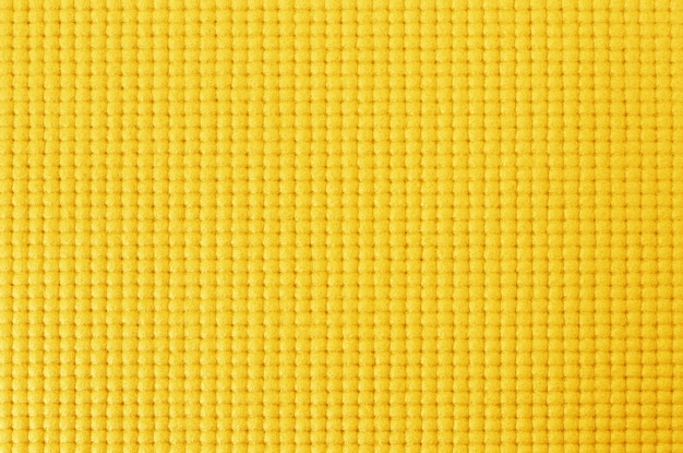 Textura de la estera de yoga de color amarillo para el fondo.