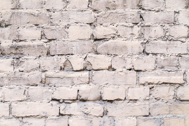 La textura de fondo abstracto de una antigua fachada de ladrillo de color rosa pálido