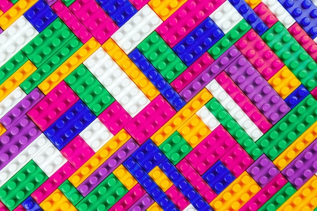 Textura de fondo abstracto de bloques constructores de colores Fondo de parte plástica colorida del constructor Montón de ladrillos de juguete de colores