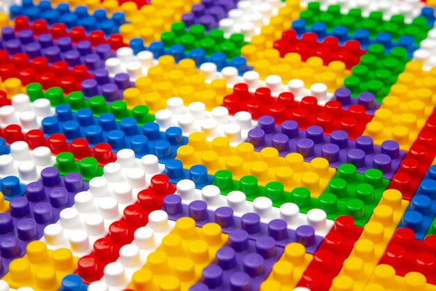 Textura de fondo abstracto de bloques constructores de colores Fondo de parte plástica colorida del constructor Montón de ladrillos de juguete de colores