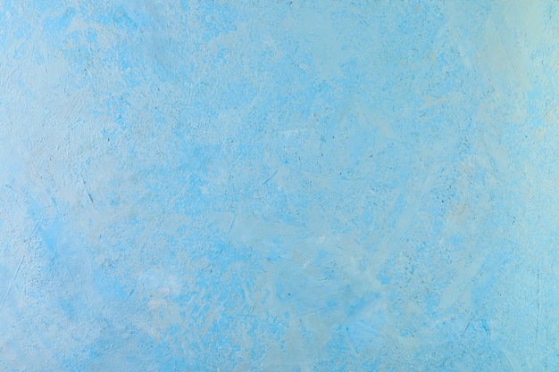 Textura de fondo abstracto de yeso rugoso con toques blancos de azul.