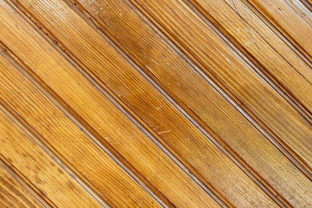 Textura de fondo marrón de una valla de madera hecha de tablones diagonales de madera natural Fondo de madera de tablones de madera