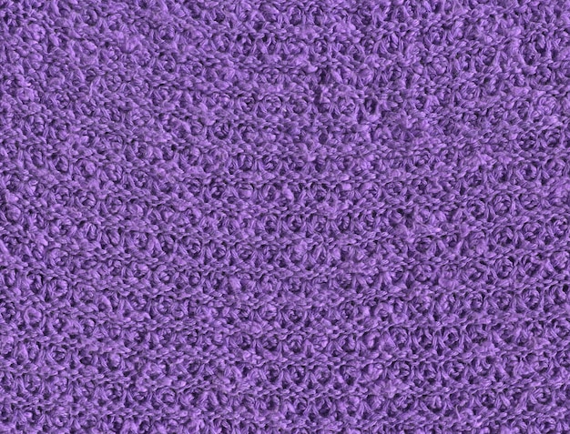 Textura de un fondo de pantalla de suéter violeta tejido