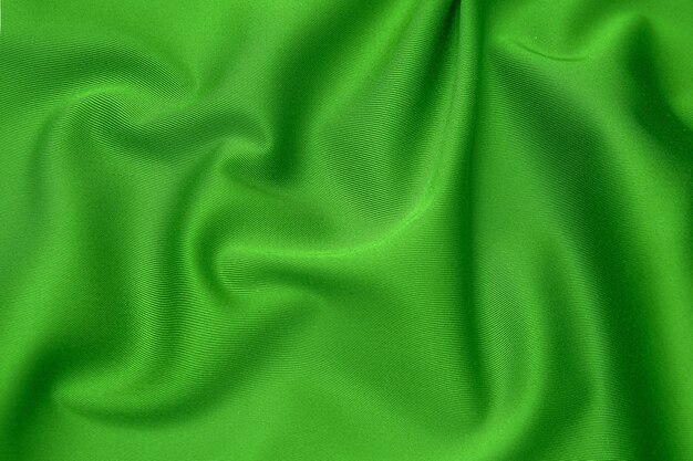 Textura, fondo, patrón. Textura de tela de seda verde. Preciosa tela de seda suave verde esmeralda.
