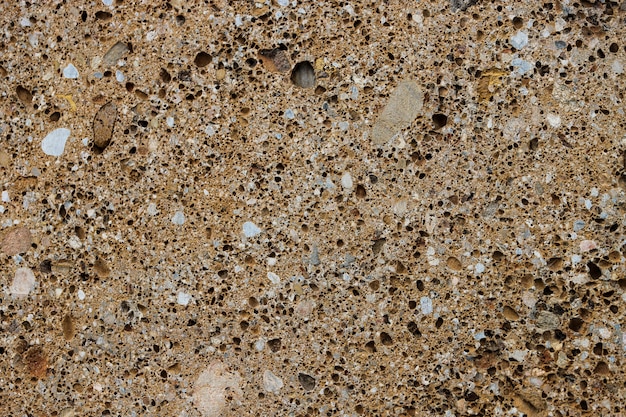 Textura de fondo de piedra de conglomerado con muchos poros y agujeros.