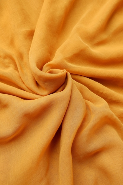 Textura de fondo de tela de color amarillo azafrán sin costuras con tela de hermoso detalle de primer plano.