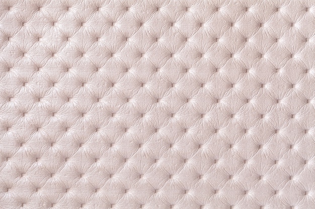 Textura de fondo de tela de cuero beige con patrón de capitone. Textil crema con estilo Chesterfield.
