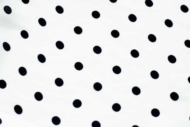 Foto textura de fondo textil de lunares clásicos puntos negros en el patrón de diseño de tela de lujo blanco