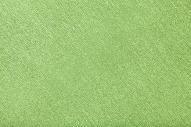 Textura del fondo verde del papel acanalado ondulado, primer.