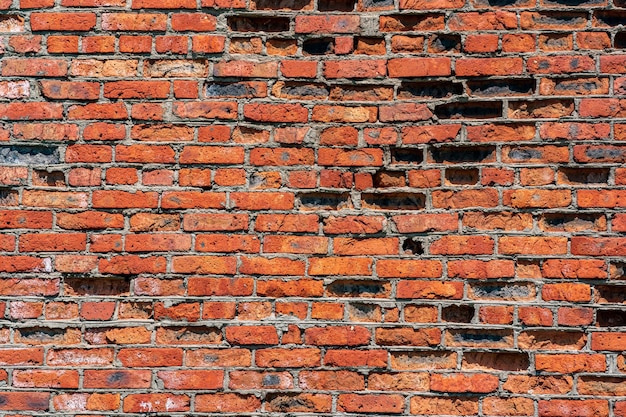 Textura de fondo de una vieja pared de ladrillo rojo muy desgastada