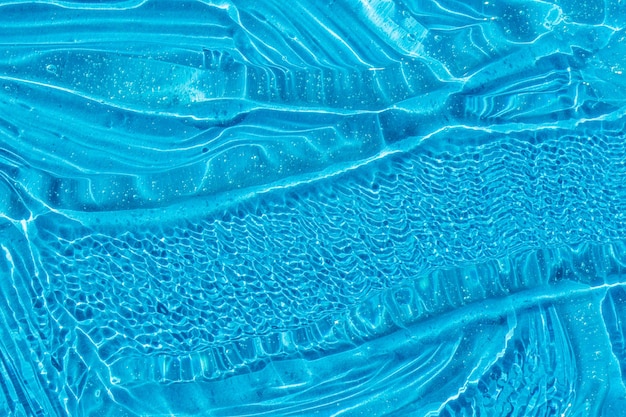 Textura de gel cosmético azul con burbujas fondo de crema hidratante de suero facial crema para el cuidado de la piel transparente