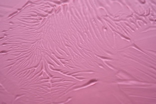 Foto la textura del gel cosmético sobre un fondo rosado