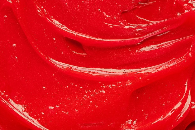 Textura de gel rojo Cosmético líquido transparente crema mancha Primer plano de muestra de producto para el cuidado de la piel Pasta de dientes o cera