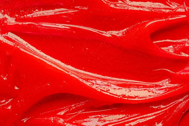 Foto textura de gel rojo cosmético líquido transparente crema mancha primer plano de muestra de producto para el cuidado de la piel pasta de dientes o cera