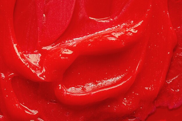 Foto textura de gel rojo cosmético líquido transparente crema mancha primer plano de muestra de producto para el cuidado de la piel pasta de dientes o cera