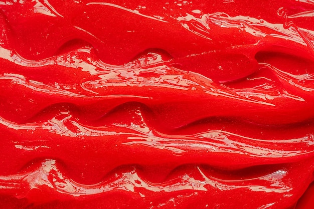 Textura de gel rojo Cosmético líquido transparente crema mancha Primer plano de muestra de producto para el cuidado de la piel Pasta de dientes o cera