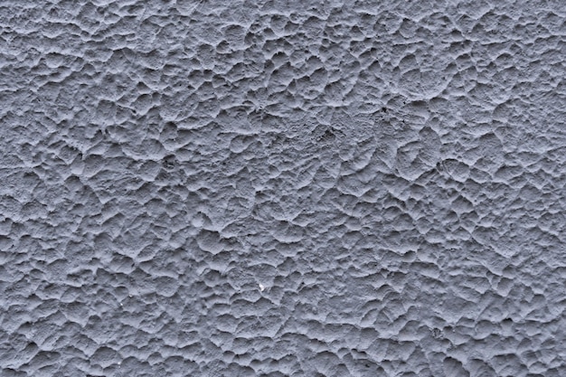 Textura gris del muro de cemento de una casa vieja Yeso texturizado decorativo