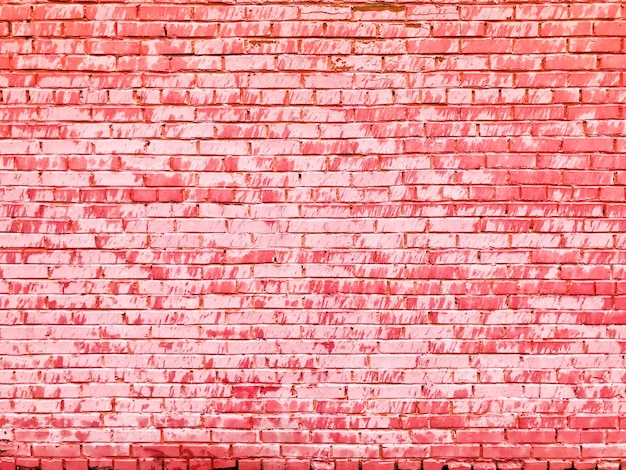 La textura de una hermosa y única pared de ladrillo agrietada, inusual, rosa, tierna, de ladrillos rectangulares