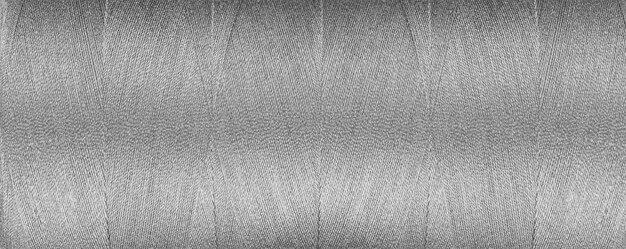 textura de hilo para una máquina de coser colores grises sobre un fondo blanco