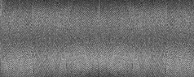 textura de hilo para una máquina de coser colores grises sobre un fondo blanco