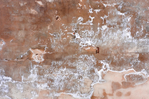 Textura de hormigón de pared que se puede utilizar como fondo Fragmento de pared con arañazos y grietas
