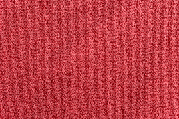 Textura de jersey de camiseta de fútbol de tela de ropa deportiva de color rojo y fondo textil.