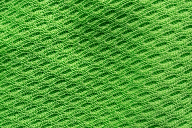 Textura de jersey de camiseta de fútbol de tela de ropa deportiva verde cerrar