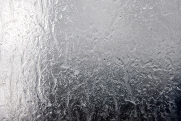 Foto textura líquida en un vaso, fondo con gotas y fugas