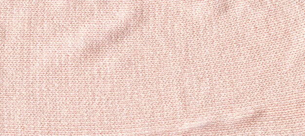 Textura de lona de tejido de punto hecho a mano en color crema beige Acogedora manta textil en tono crema de cerca