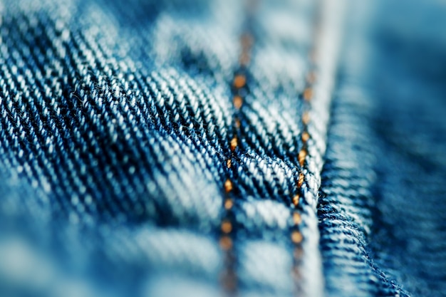 Textura de mezclilla de jeans de cerca, enfoque solo un punto, fondo de pantalla suave borroneado