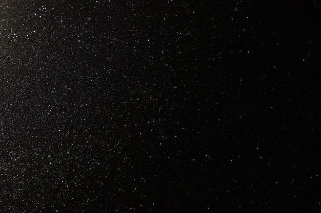 Textura negra con micro-relieve y purpurina similar al cielo nocturno con estrellas