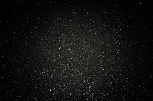 Foto textura negra con micro-relieve y purpurina. textura de brillo negro con centro iluminado