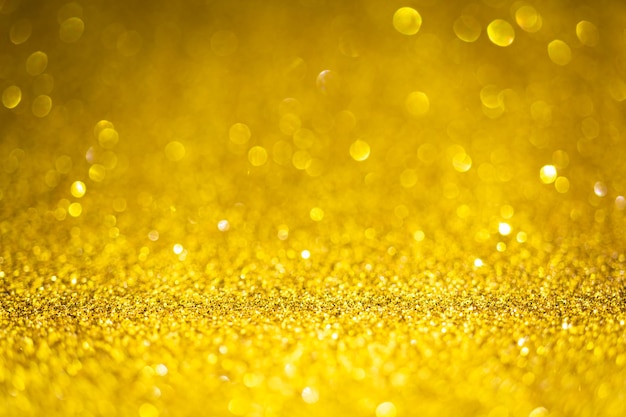 Textura de oro brillo brillante. Enfoque selectivo. Superficie brillante, luces brillantes y efectos bokeh. Navidad y foto de fondo festivo.