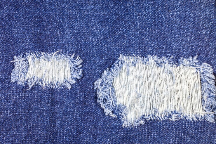 Textura de pantalones vaqueros rasgados azul