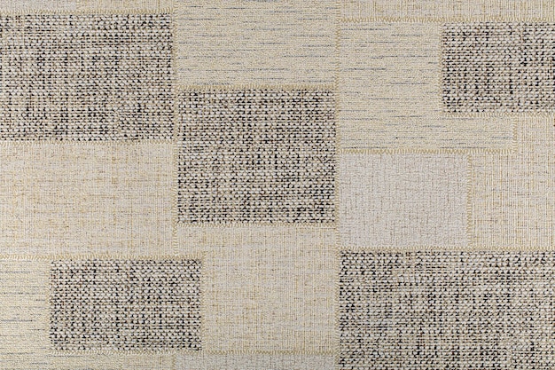 Textura de papel beige con cuadrados en forma de parches de arpillera