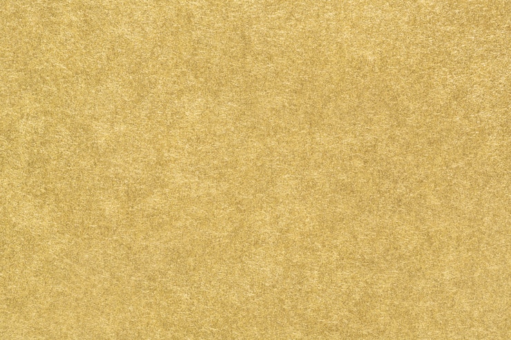 Foto textura de papel dorado. fondo abstracto de lámina de oro mate suave. de cerca.
